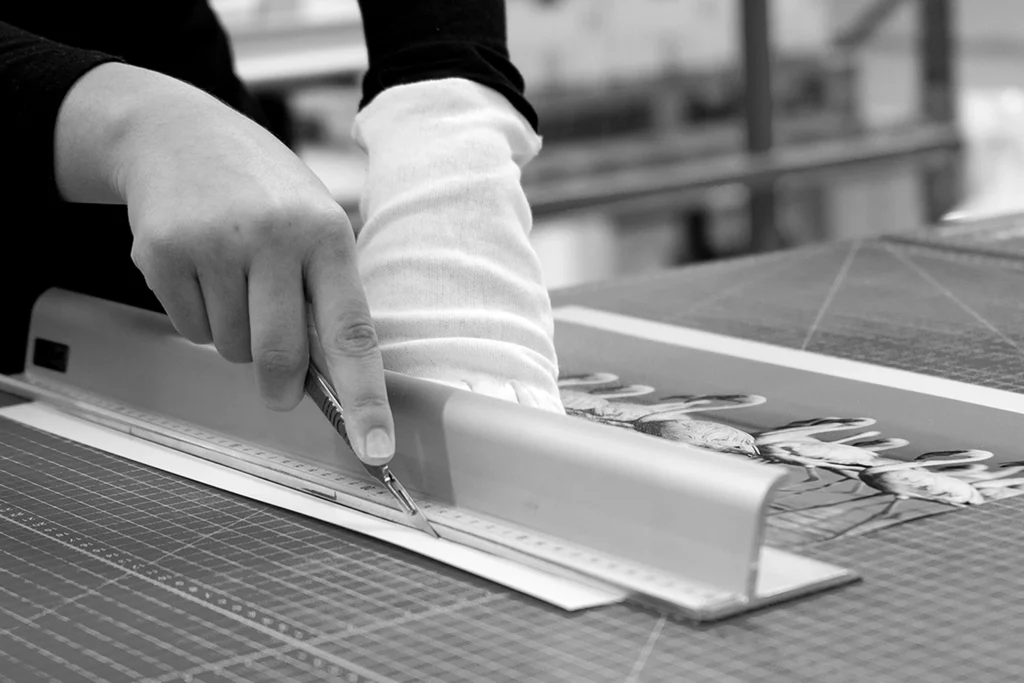 Person cutting page on bleed line